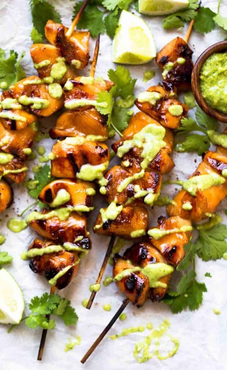 grilled chicken skewers on a white background