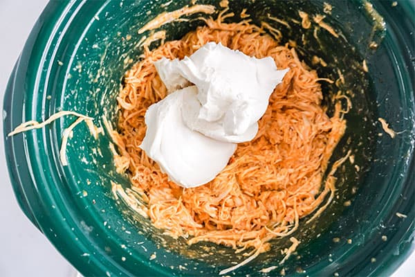 cream cheese and shredded chicken in a slow cooker