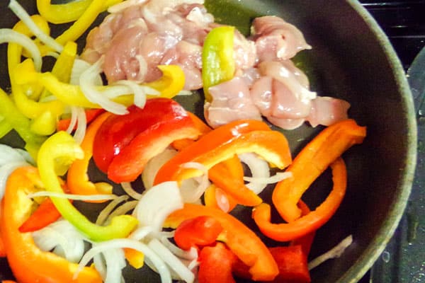 olive oil, chicken, bell pepper and onion  in a skillet