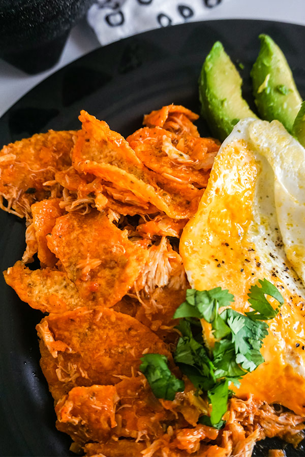 close up of Chicken Chilaquiles on a black plate