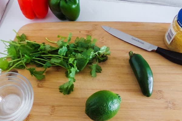 a knife, glass bowls and ingredients needed to make  Cilantro Lime Chicken 