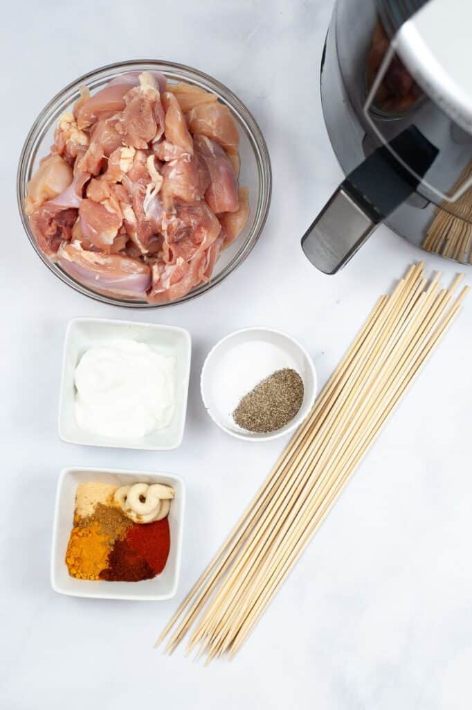ingredients and kitchen tools needed to make air fryer tandoori chicken.