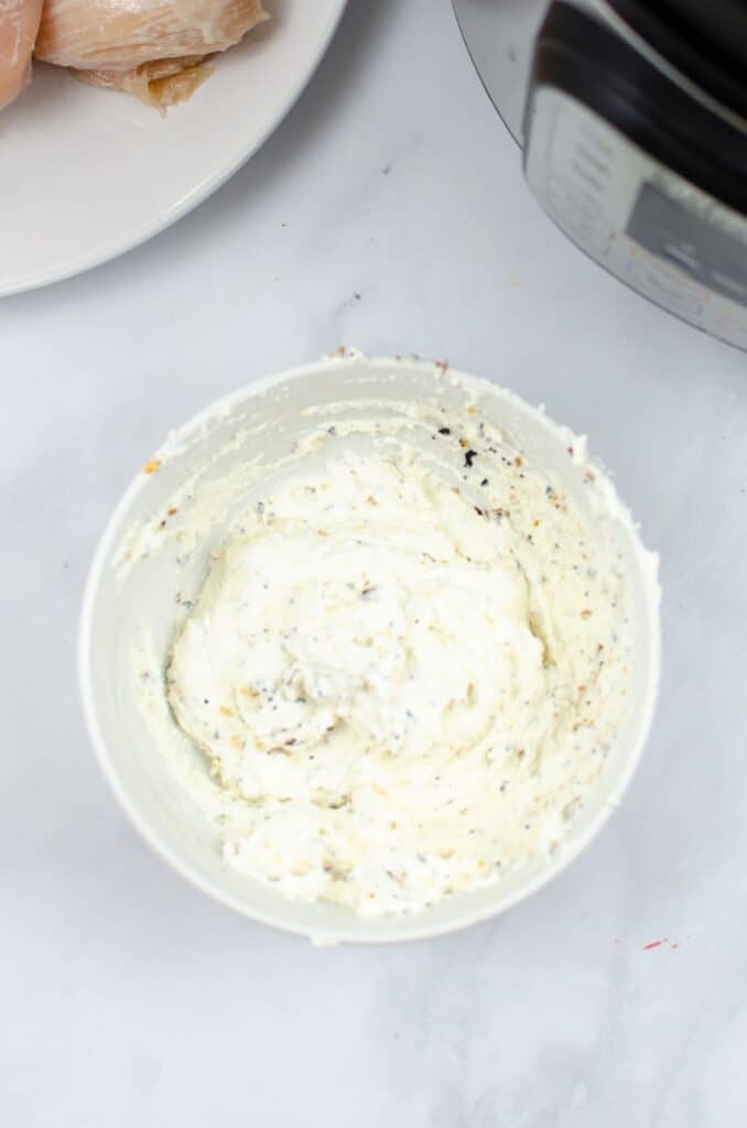 cream cheese and seasoning combined in a white bowl