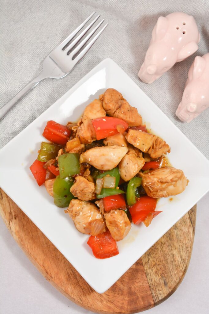 Keto Chicken Stir Fry on a plate with a fork on the side.