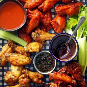 array of chicken wings with various sauces