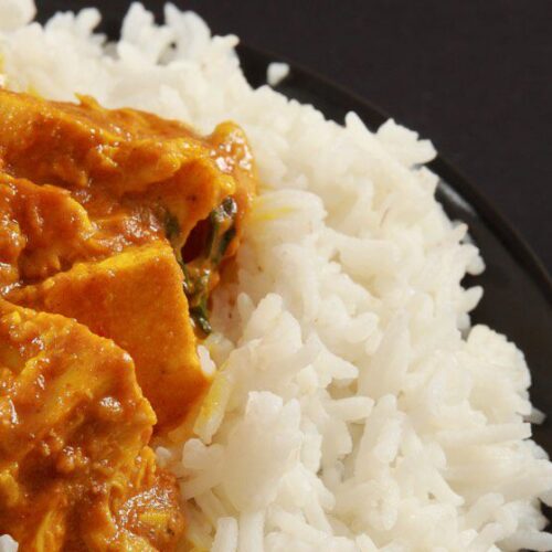 chicken curry alongside rice