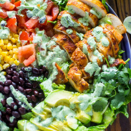 bowl of southwest chicken salad topped with a dressing