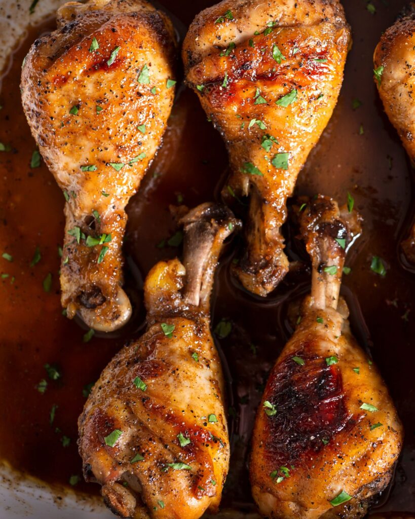 cooked chicken legs  in a sauce.