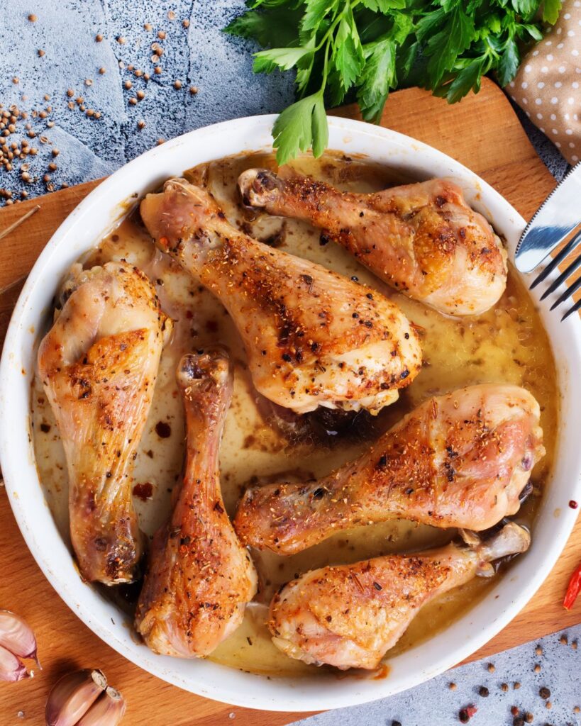cooked chicken legs on a serving plate.